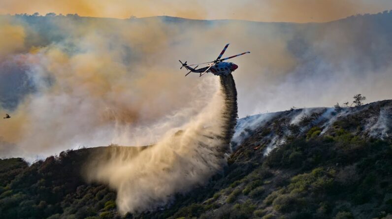 Wildfire burns across 200 acres in Orange County, California, damaging homes